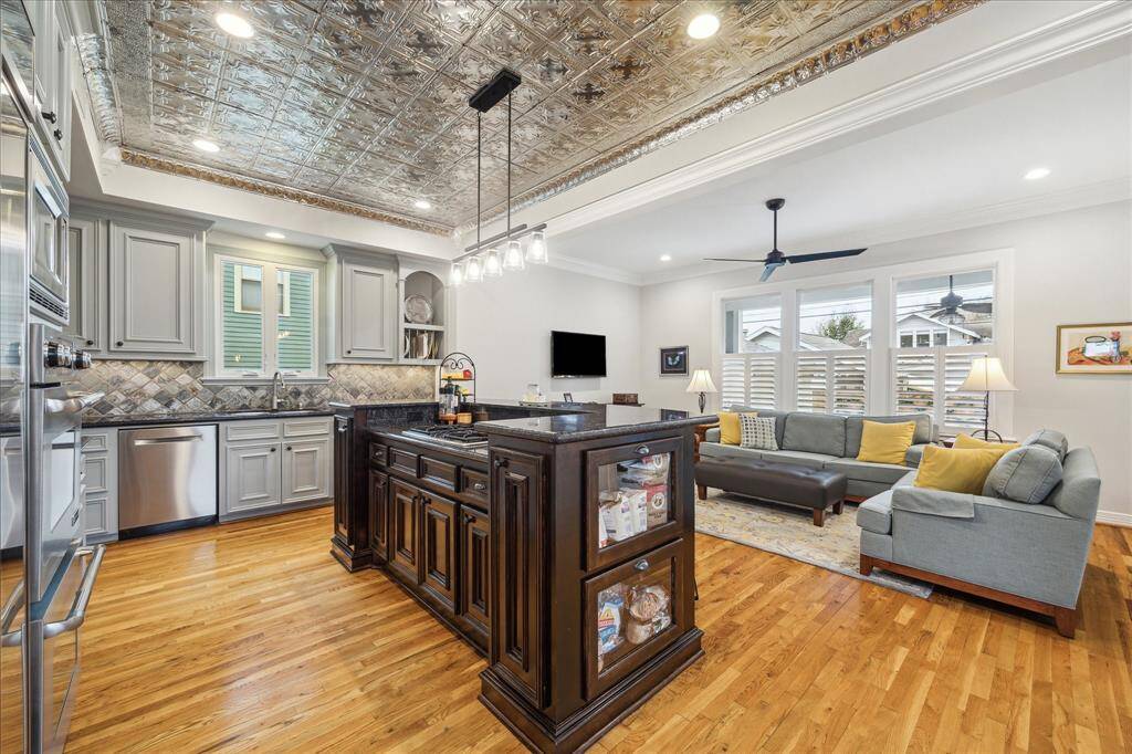 This exquisite kitchen is elevated by the captivating tin ceiling tiles, which infuse the space with timeless charm and a touch of architectural elegance, making it truly one-of-a-kind.