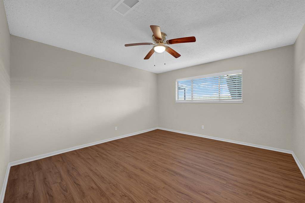 Cozy primary bedroom offers natural light with a full bathroom conveniently located to your right as you walk in
