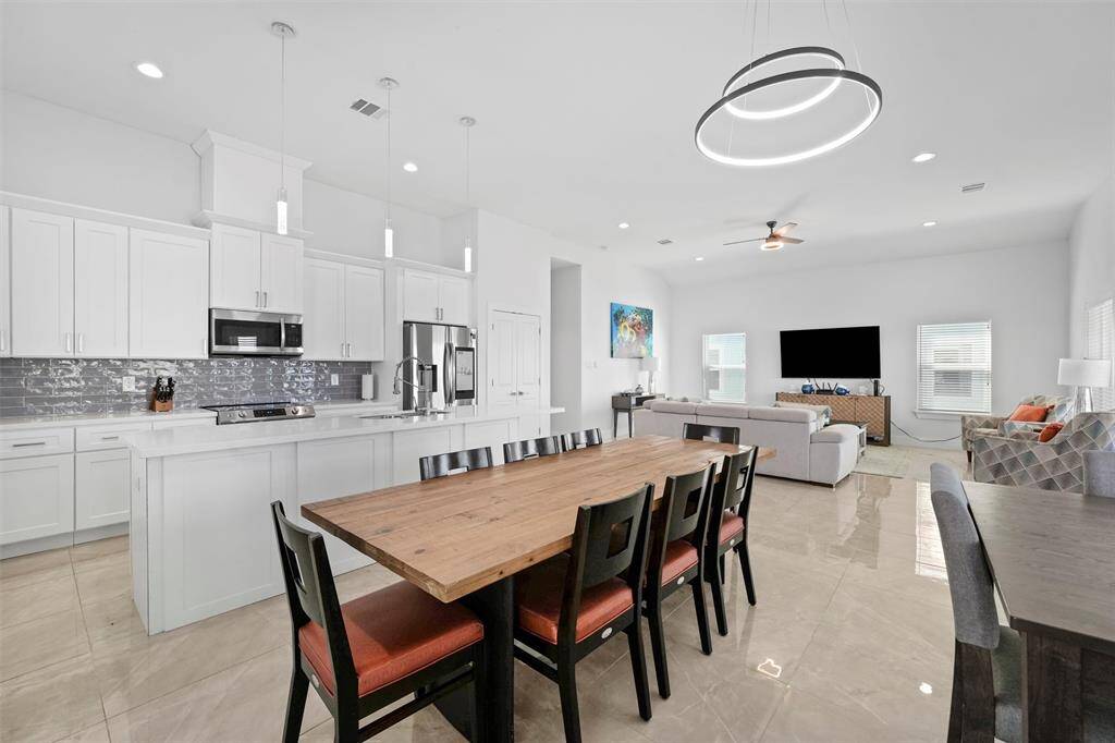 This dining space offers flexibility for entertaining with room for two tables to accommodate large gatherings. Prefer a more open layout? Remove the extra seating to create a more spacious and airy feel.