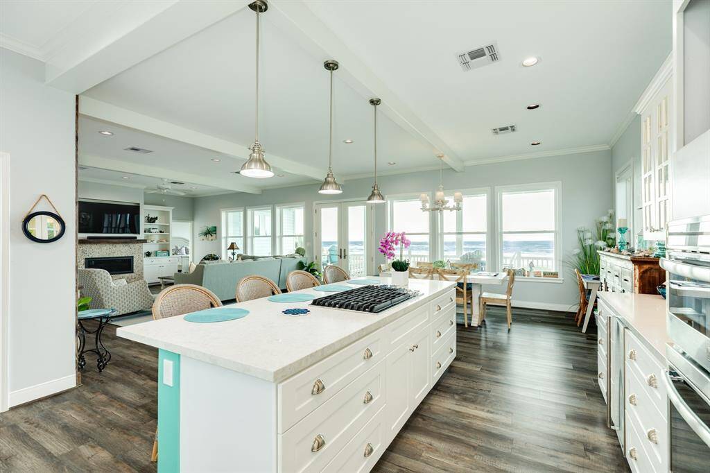 View down the kitchen 'runway' towards the dining area and deck beyond.