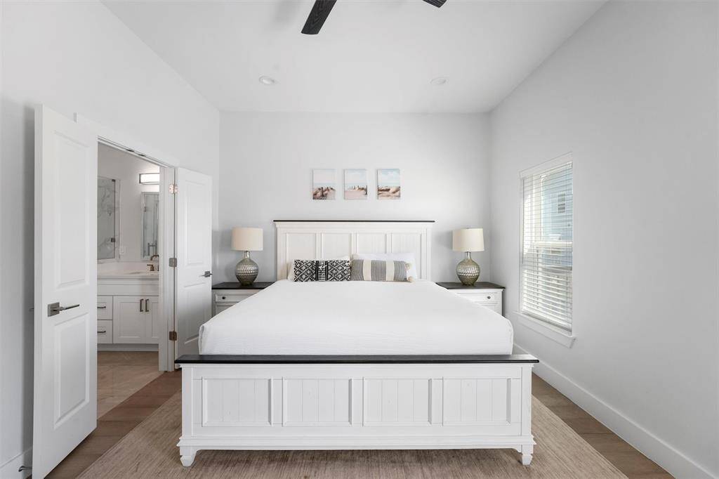 This serene primary suite is designed for comfort and relaxation, featuring high ceilings, abundant natural light, and a spa-like en-suite bathroom.