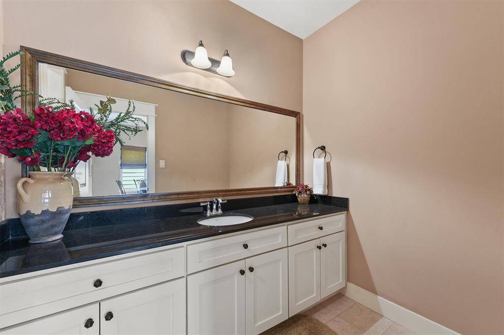 Second bathroom has a large counter top and shower/tub combo
