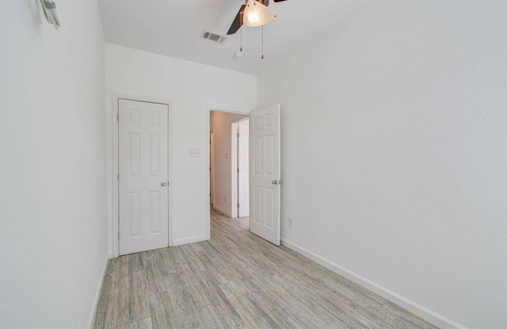 View of bedroom from window. Left door is closet.