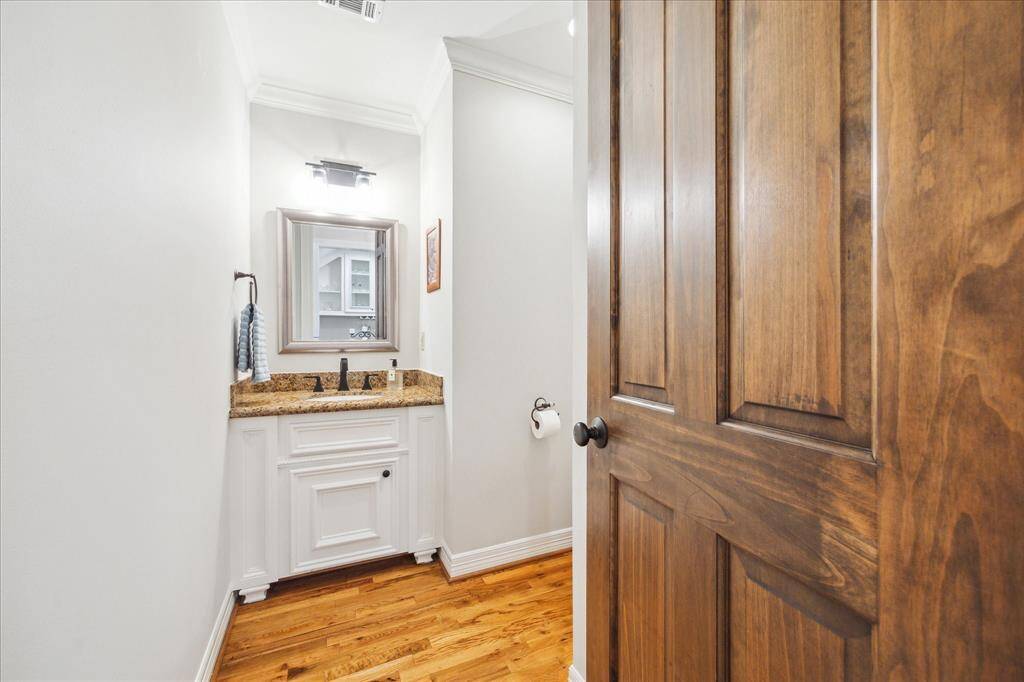 A conveniently placed half bath is situated on the first floor, providing easy access from both the dining and living areas.