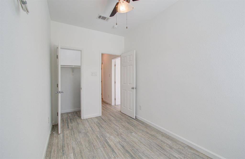 View of bedroom from window, with view of closet.