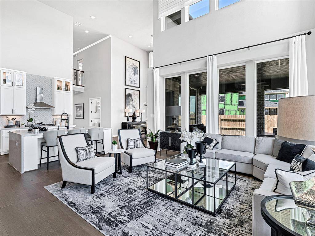The spacious living area boasts a sleek, contemporary design with neutral tones and elegant accents, perfect for entertaining or relaxing.