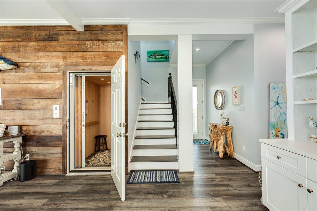 Elevator & staircase in view leading to the 2nd level of home.