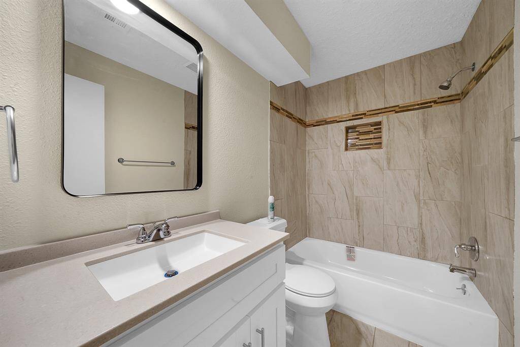 Beautiful finishes in this secondary bathroom with shower-tub duo