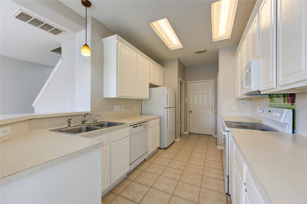 Kitchen has plenty of cabinets and workspace.