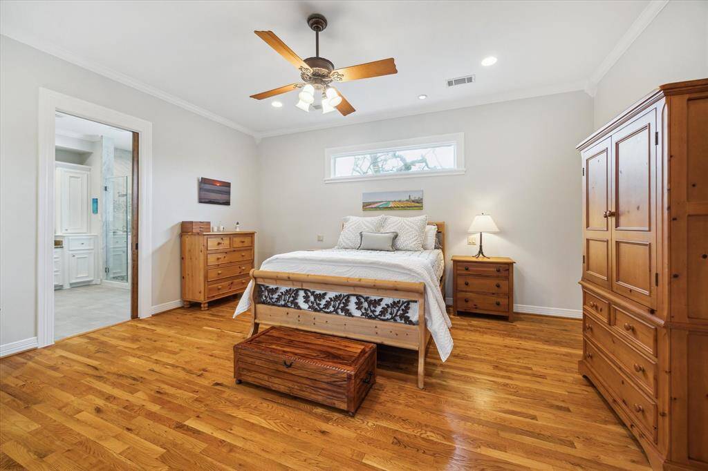 One side of the primary bedroom is dedicated to rest, featuring a tranquil sleep area highlighted by a beautiful transom window.