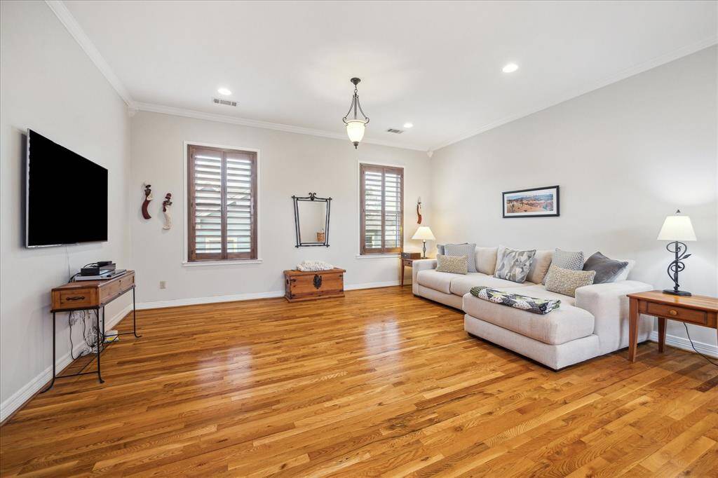 The other side of the primary bedroom is designed for relaxation, featuring a spacious seating area wonderful for unwinding.