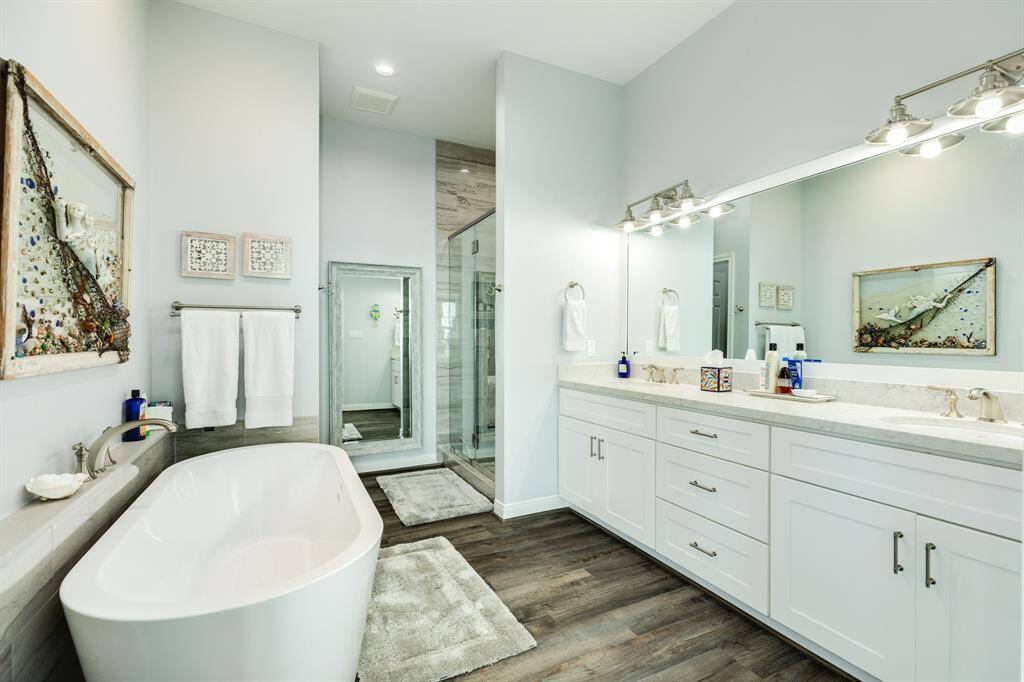 Primary bath with soaking tub, separate walk in shower, water closet, double vanity sinks & a walk in closet.