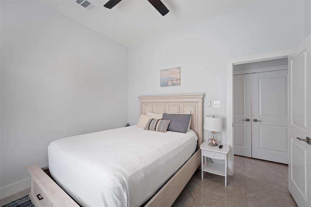 This cozy and inviting 3rd bedroom offers a peaceful retreat with soft coastal tones, high ceilings, and plenty of natural light.