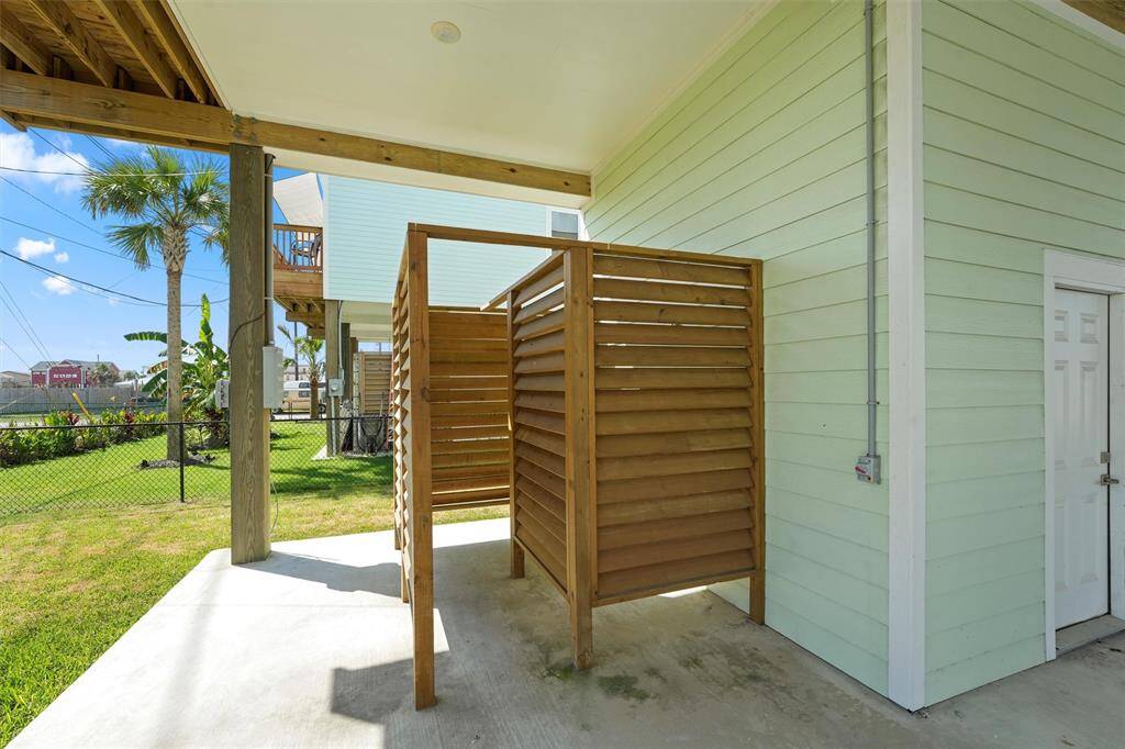 Rinse off after a day at the beach in this private outdoor shower, perfect for keeping the sand outside while enjoying the coastal lifestyle.