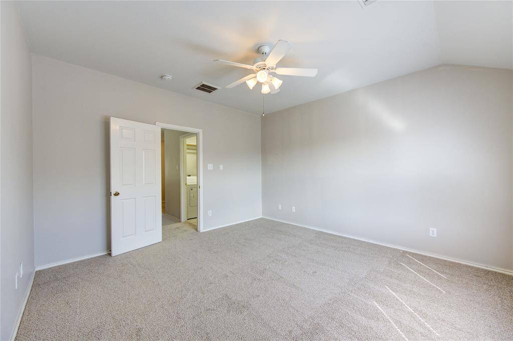Primary bedroom with tall ceilings and ceiling fan for your comfort.