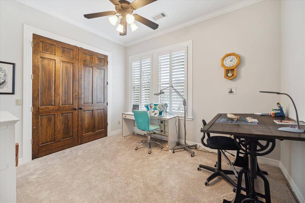 Bedroom #3 features plush carpeting, a ceiling fan with light, and a spacious closet, offering both comfort and functionality.