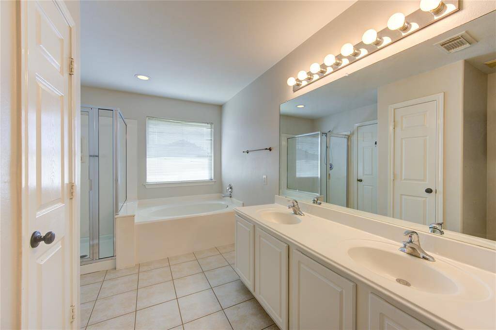 En-suite bathroom has dual sinks, soaking tub and walk in shower.