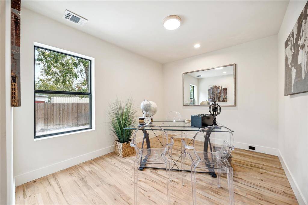The first floor bedroom has an adjoining den with direct access to the back patio deck and can serve as a guest suite or a home office.