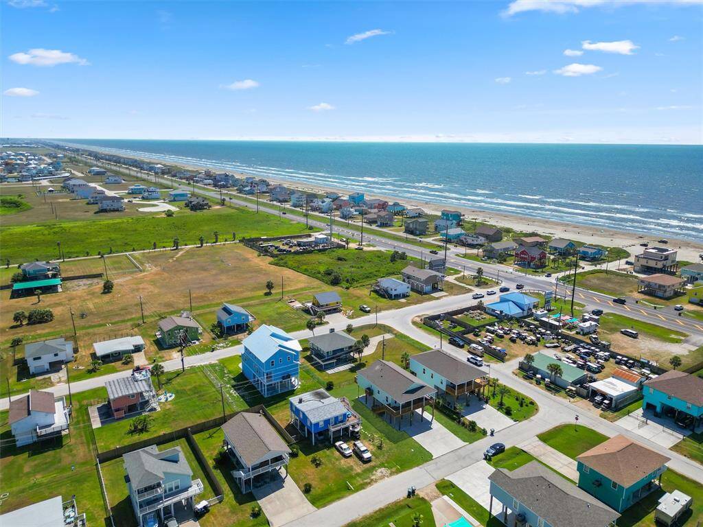This aerial view highlights the prime location of this coastal retreat, just moments from the beach with easy drive-on access.