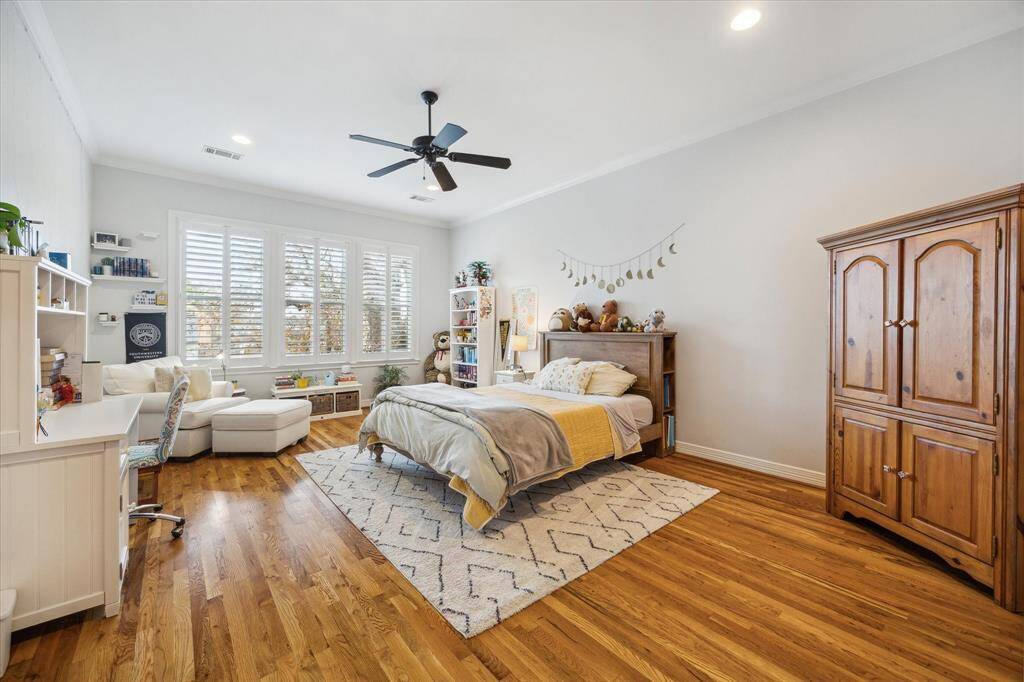 This expansive bedroom (#4) features recessed lighting, wood flooring, a ceiling fan, and an ensuite bath. With its generous size, this versatile space could also serve as an incredible game room.