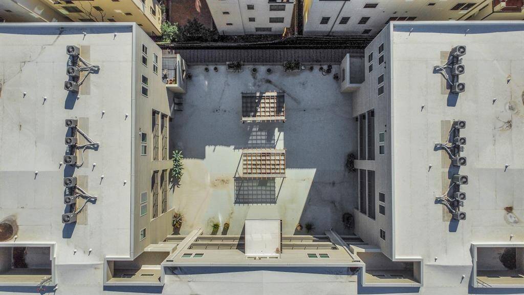 An aerial view showcases the building’s central courtyard, highlighting its spacious and well-designed layout—perfect for comfortable urban living.