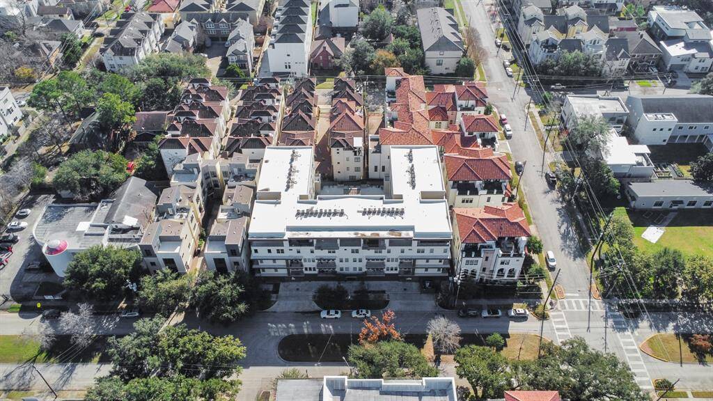 This aerial photo showcases a residential neighborhood with a mix of modern and traditional homes.