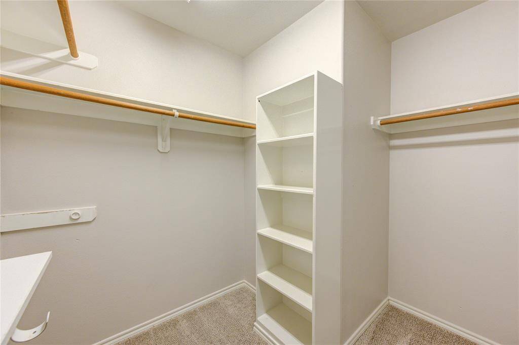 Spacious closet with some extra shelving for your convenience.