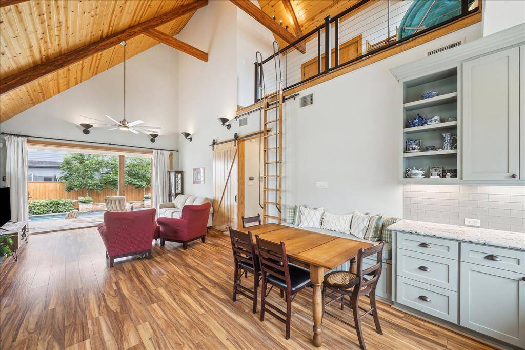 The dining area is enhanced with a built-in bench, offering comfortable seating and adding a cozy, inviting touch to the space. Take a peek above into the fantastic loft space!