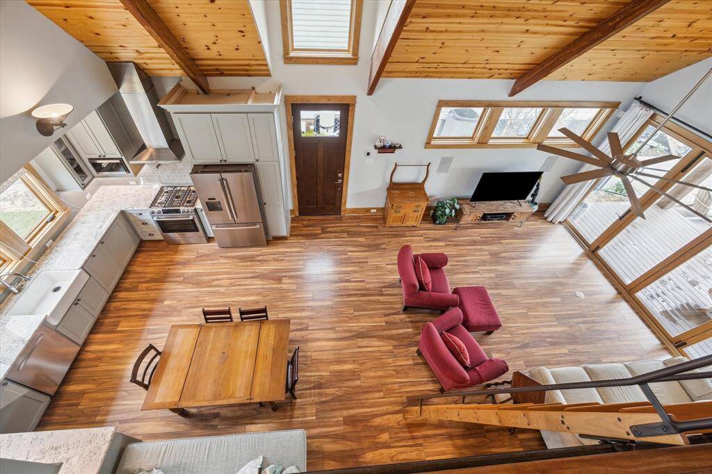 The amazing view from the loft highlights the open layout of the pool house. Note the sliding wood ladder down.