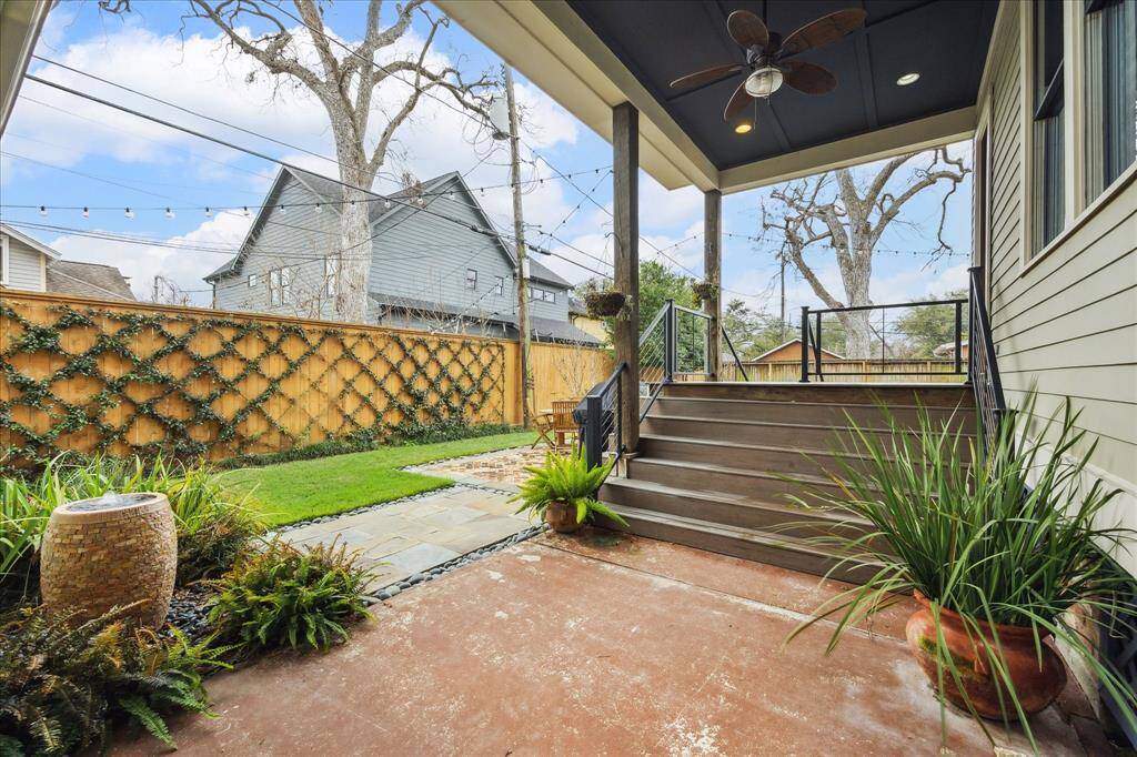 Just off the back is a covered patio, offering additional space for dining and seating, great for enjoying outdoor meals or relaxing in the shade.