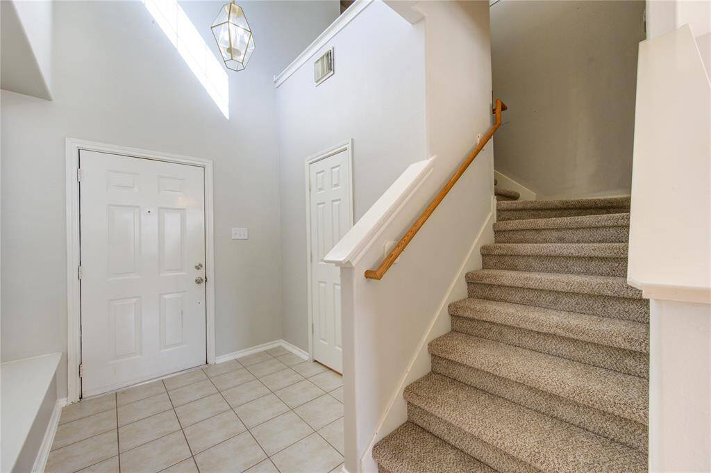 Front entry with tall ceiling and privately located powder room- just to the left of the door.