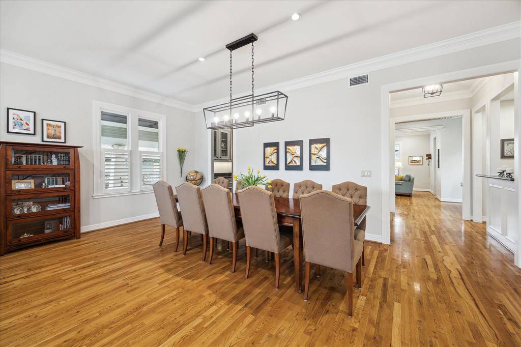 You have easy access to the kitchen from the dining area, either through the convenient butler’s pantry on the left or by the stunning wet bar to the right, offering a seamless transition between spaces.
