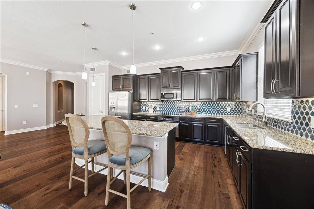 Alternate view of Kitchen, featuring handsome cabinets, ample storage, and amazing entertaining space.