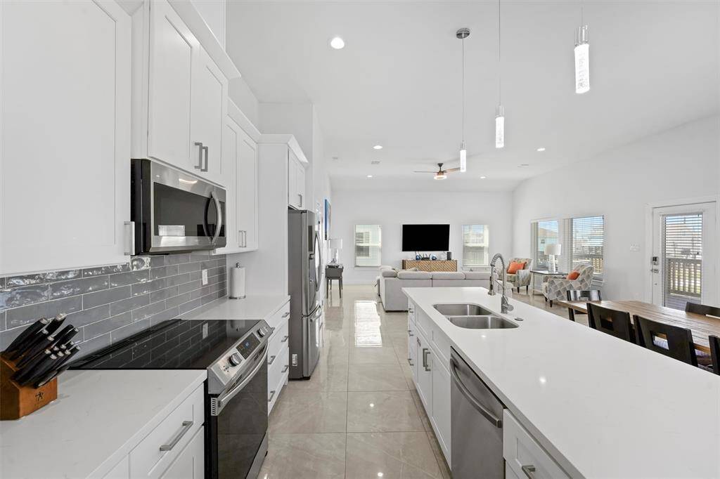 The perfect blend of style and functionality. This open-concept kitchen flows seamlessly into the living and dining areas, creating a bright and inviting space for entertaining or everyday living.