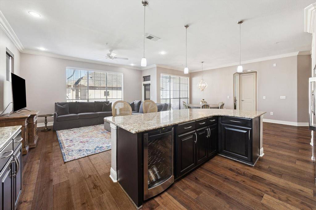 Featuring a built-in wine fridge, the kitchen overlooks the spacious living and dining areas.