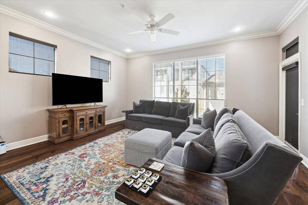 The spacious living area boasts numerous windows and convenient access to the outdoor balcony.