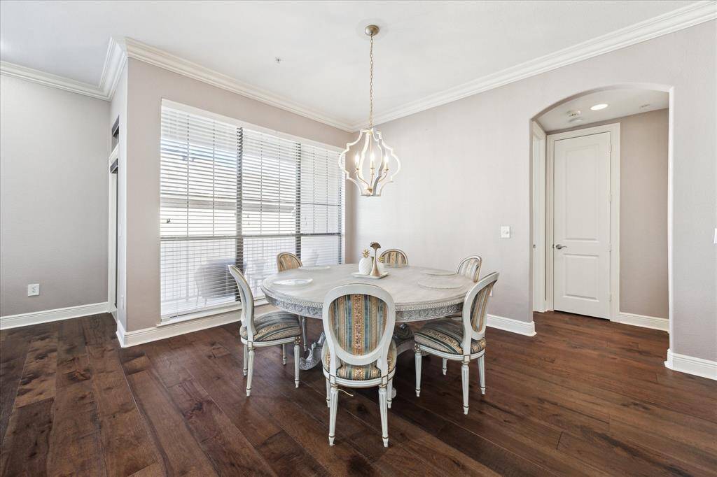 Dedicated dining area featuring abundant natural light, elegant flooring, and an attractive chandelier.