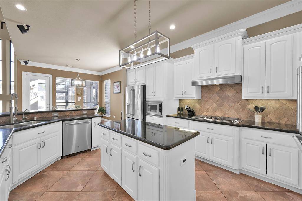 The kitchen has lots of counter space and a 5 burner gas stove