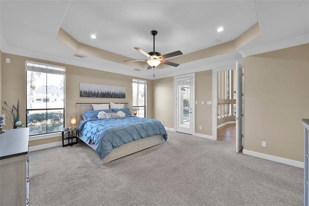 Primary bedroom features a door to the screened in porch
