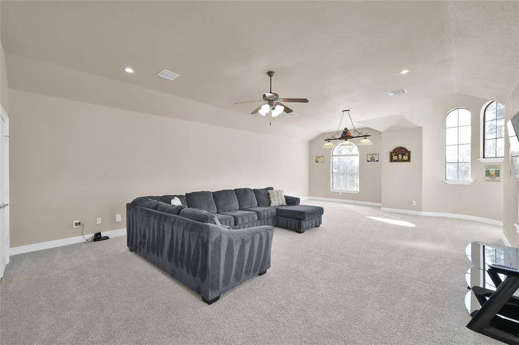 Massive game room that can fit a sectional, pool table and a bar with plenty of extra space