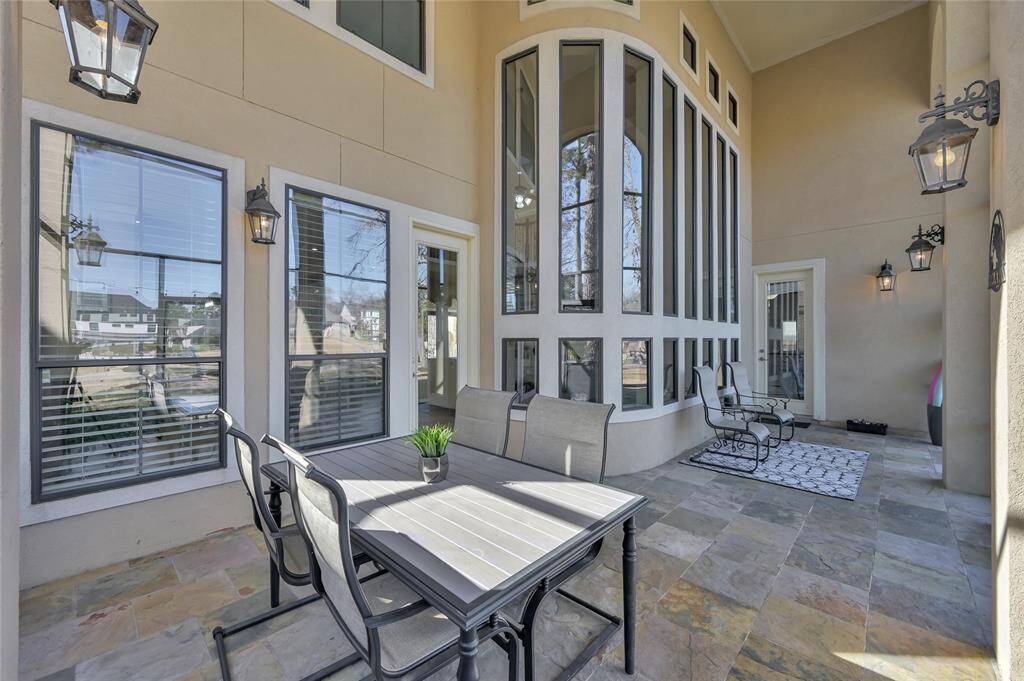 Screened in porch overlooking pool and lake