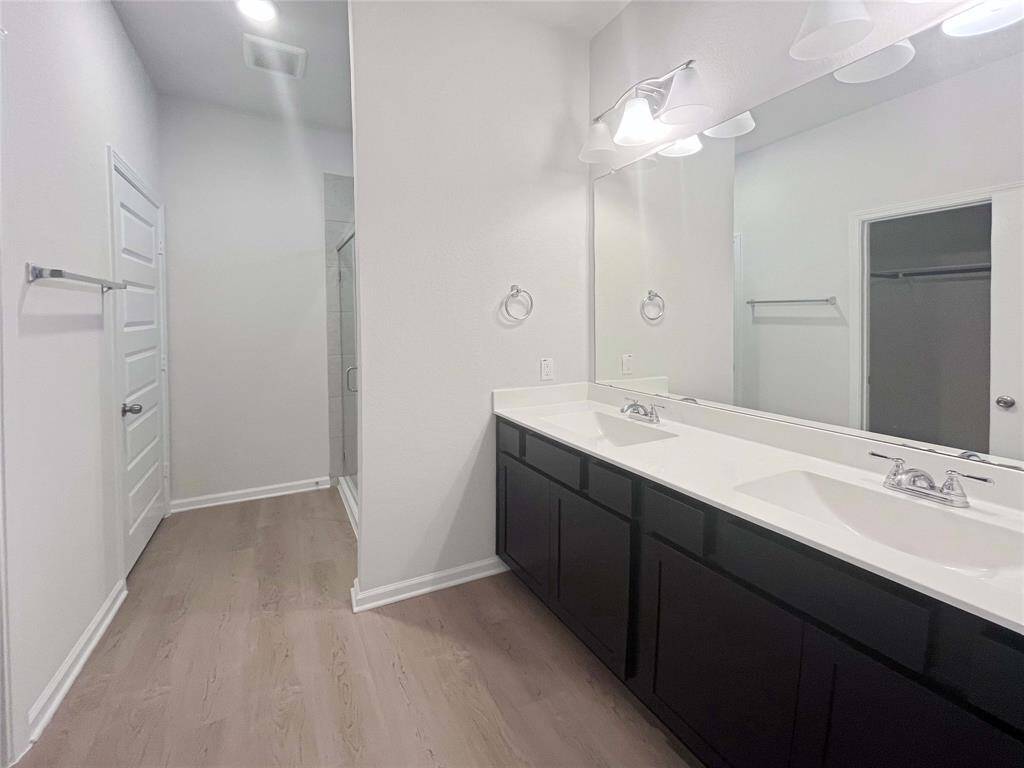 Owner's Bathroom with Dual Sinks and Walk-in Shower