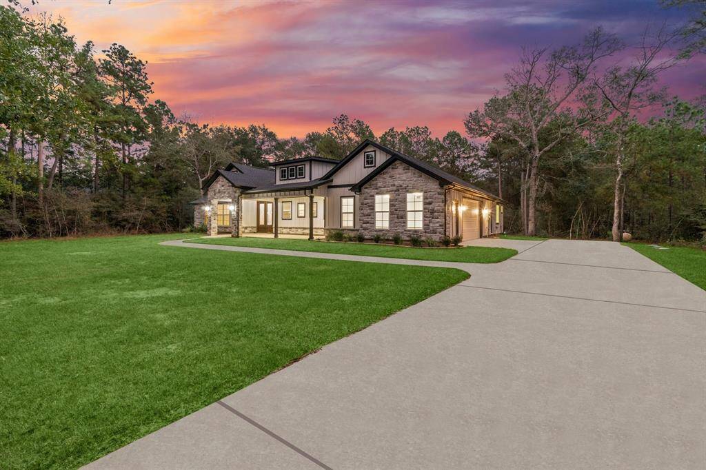 Set back from the road for ultimate privacy, long driveway leading to a 2 car garage, concrete walkway leading to the spacious, covered patio.