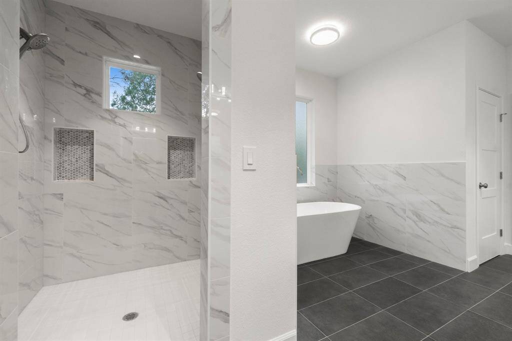 Large walk in shower with built in cubbies.