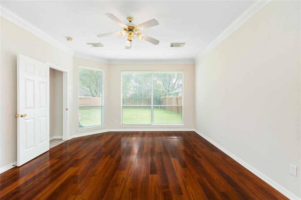 Located downstairs, the Primary Bedroom looks out to the backyard