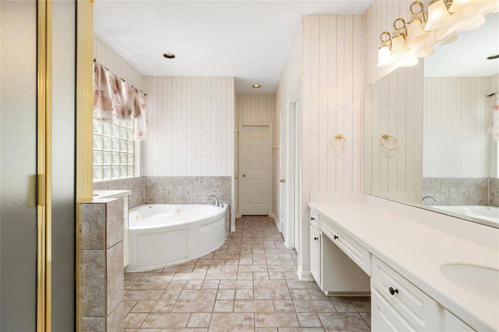 You'll find a walk-in shower, jetted tub, double sinks, and vanity seat in the Primary Bathroom