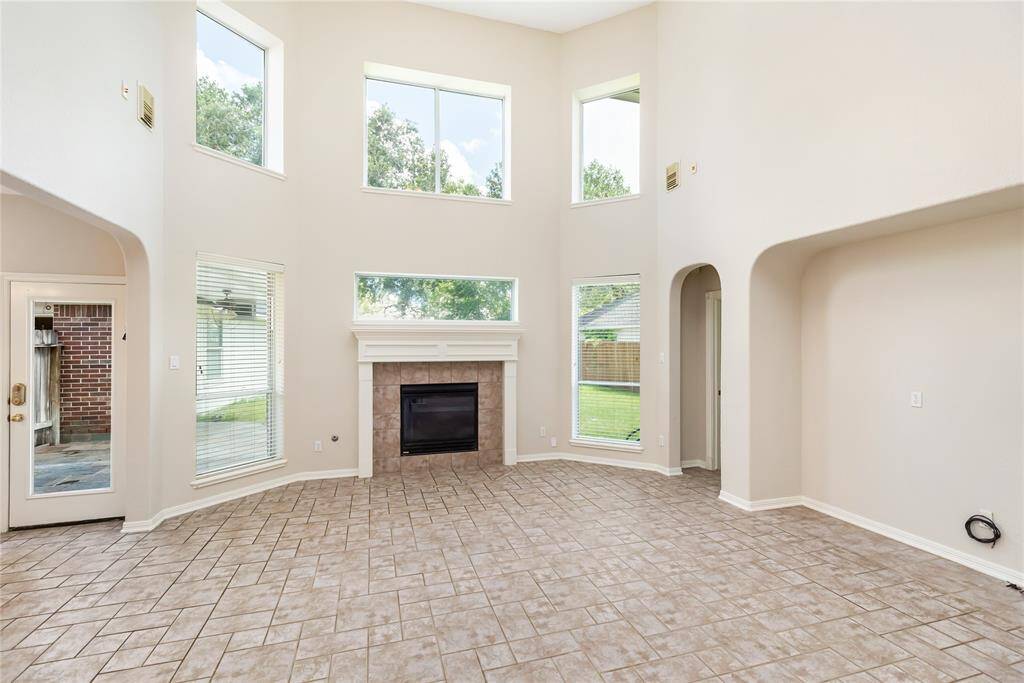 Fully of natural light, the Family Room is open to the kitchen, and features a gaslog fireplace