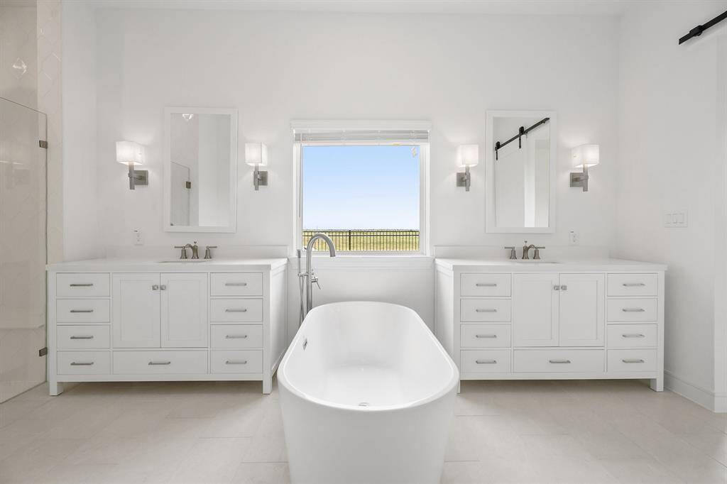 Luxurious primary bath with dual vanities and freestanding tub