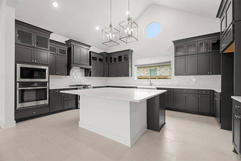 Stylish kitchen with quartz countertops and grey cabinets