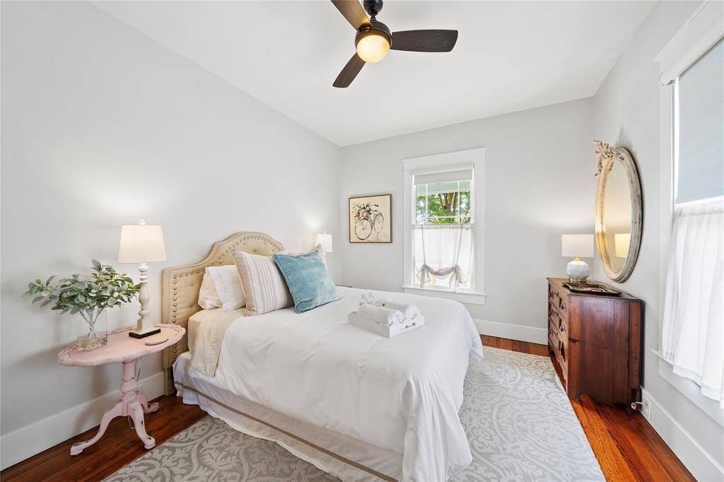 Large bedrooms with custom black out shades and original hardwood flooring.